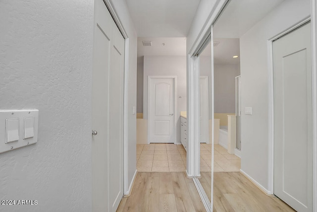 hall with light hardwood / wood-style flooring