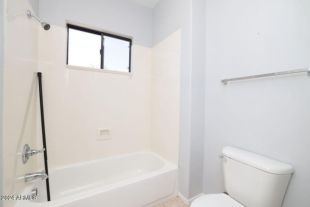 bathroom featuring shower / tub combination and toilet