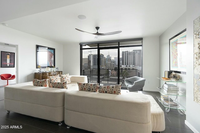 living room featuring a wealth of natural light, ceiling fan, and floor to ceiling windows