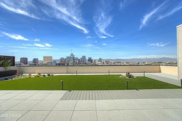 view of community featuring a mountain view and a yard