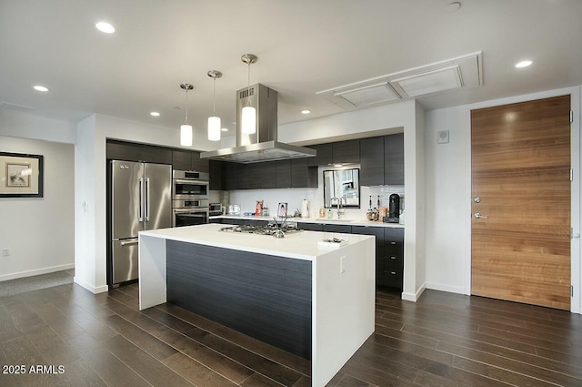 kitchen featuring pendant lighting, a center island, dark wood-type flooring, appliances with stainless steel finishes, and island range hood