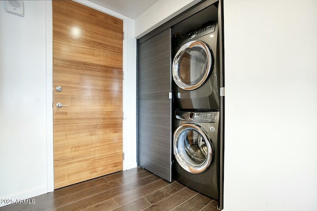 washroom with stacked washing maching and dryer