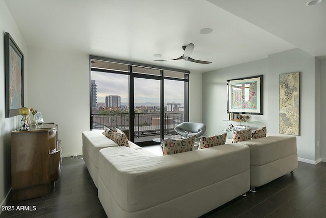 living room with dark hardwood / wood-style flooring, floor to ceiling windows, and ceiling fan