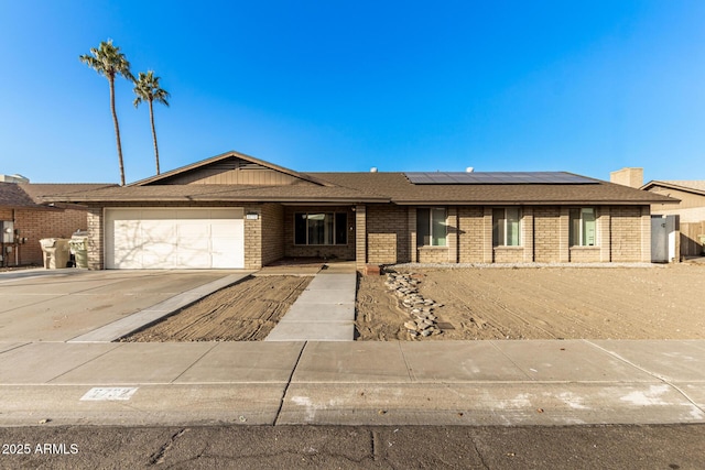 view of front of house with a garage and solar panels