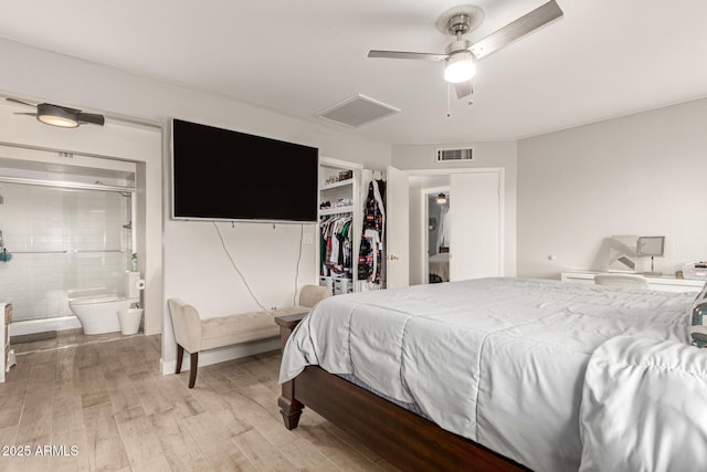 bedroom with ceiling fan, a closet, light hardwood / wood-style floors, and ensuite bath