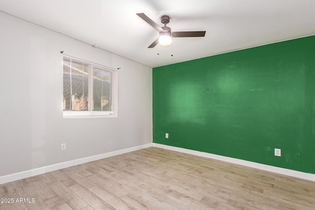 empty room featuring ceiling fan and light hardwood / wood-style floors