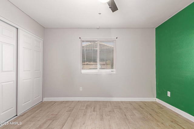 unfurnished bedroom with light hardwood / wood-style floors, a closet, and ceiling fan