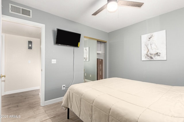 bedroom featuring ceiling fan, a closet, and light wood-type flooring