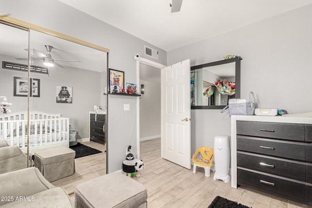 bedroom featuring ceiling fan, light hardwood / wood-style floors, and a closet