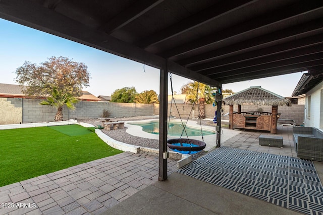 view of patio with a fenced in pool and a gazebo