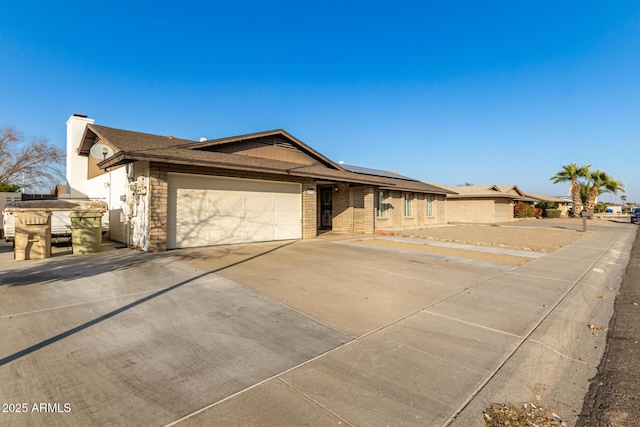 view of front of home featuring a garage and solar panels