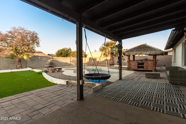 view of patio featuring a fenced in pool and a gazebo