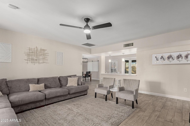 living room featuring ceiling fan and wood-type flooring