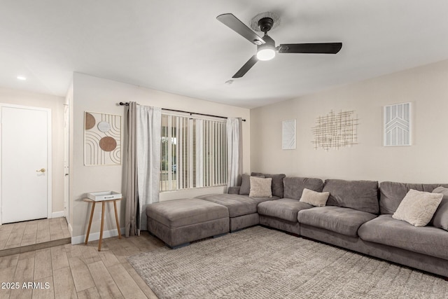 living room with ceiling fan and light wood-type flooring