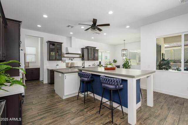 1221 E Paseo Way, Phoenix, AZ 85042 - kitchen featuring ceiling fan, a center island, recessed lighting, dark wood finished floors, and glass insert cabinets