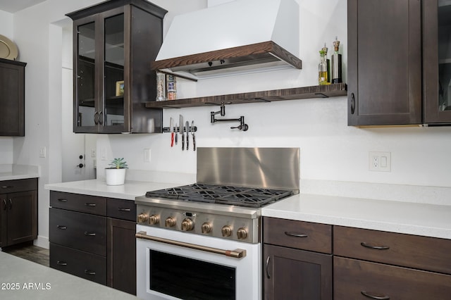 1221 E Paseo Way, Phoenix, AZ 85042 - kitchen featuring premium range hood, dark brown cabinets, gas range oven, and light countertops
