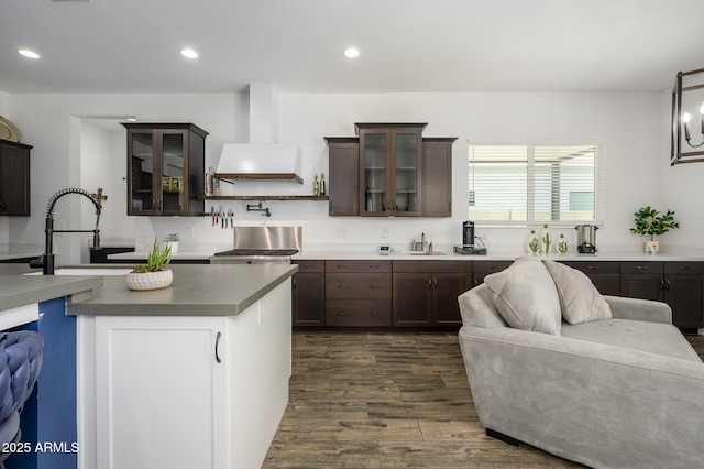 1221 E Paseo Way, Phoenix, AZ 85042 - kitchen with a sink, wall chimney range hood, dark wood finished floors, dark brown cabinets, and recessed lighting