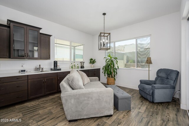 1221 E Paseo Way, Phoenix, AZ 85042 - living area featuring dark wood finished floors, a chandelier, and baseboards