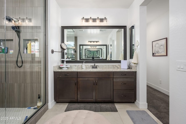1221 E Paseo Way, Phoenix, AZ 85042 - bathroom with a stall shower, vanity, baseboards, and tile patterned flooring