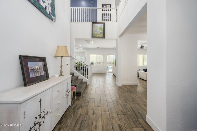 1221 E Paseo Way, Phoenix, AZ 85042 - entrance foyer with stairs, dark wood-style flooring, ceiling fan, baseboards, and a towering ceiling