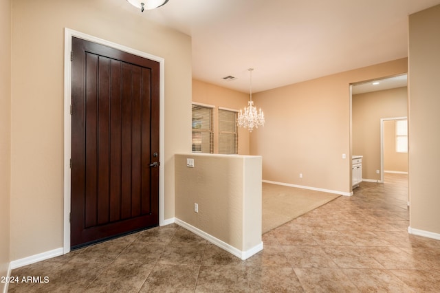 entrance foyer with a chandelier and tile patterned flooring