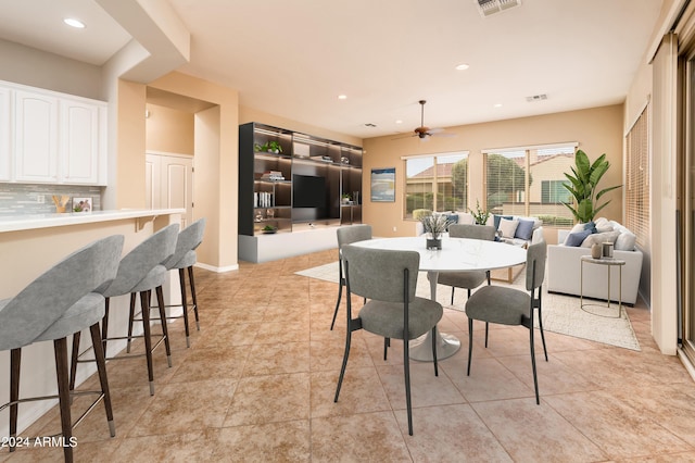 tiled dining room with ceiling fan