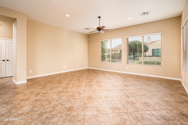 empty room with light tile patterned flooring and ceiling fan