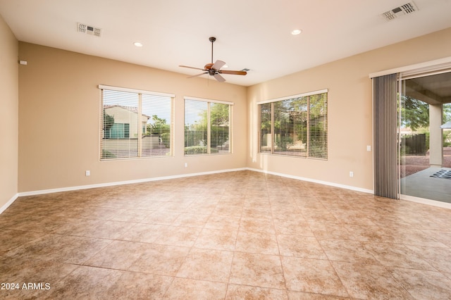 empty room with light tile patterned flooring and ceiling fan