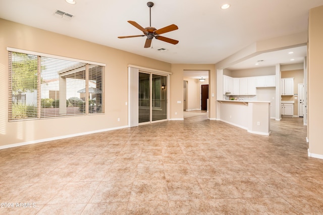 unfurnished living room with ceiling fan