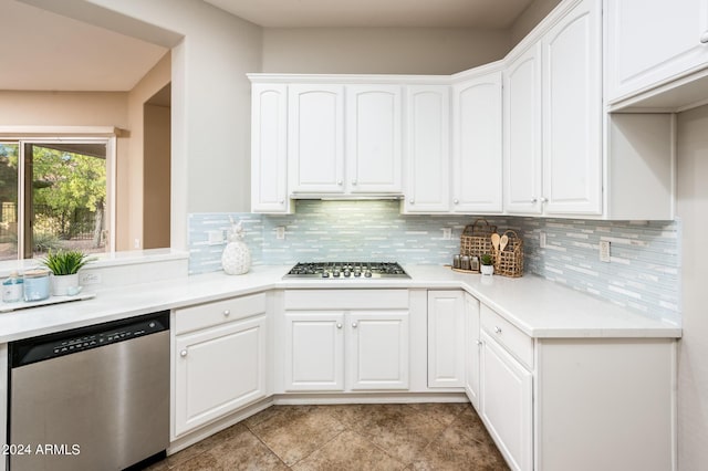 kitchen featuring white cabinetry, stainless steel appliances, and backsplash