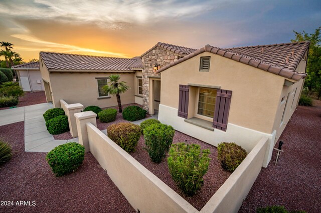 mediterranean / spanish-style home with a garage