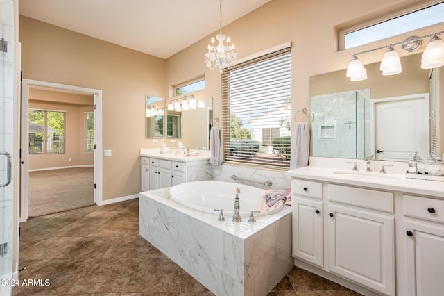 bathroom with vanity, an inviting chandelier, and plus walk in shower