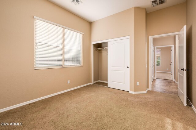 unfurnished bedroom featuring carpet flooring and a closet