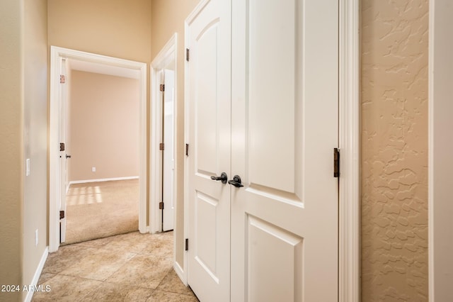 corridor with light colored carpet