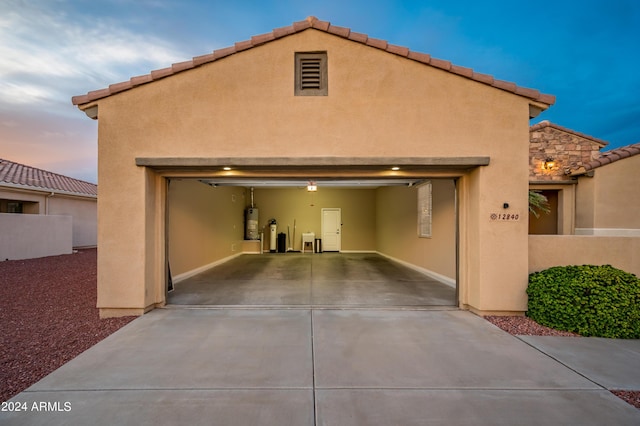 exterior space with a garage and water heater