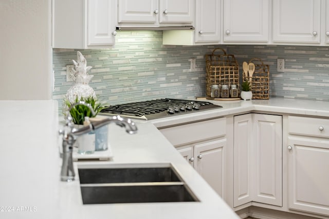 kitchen with white cabinetry, stainless steel gas cooktop, and sink