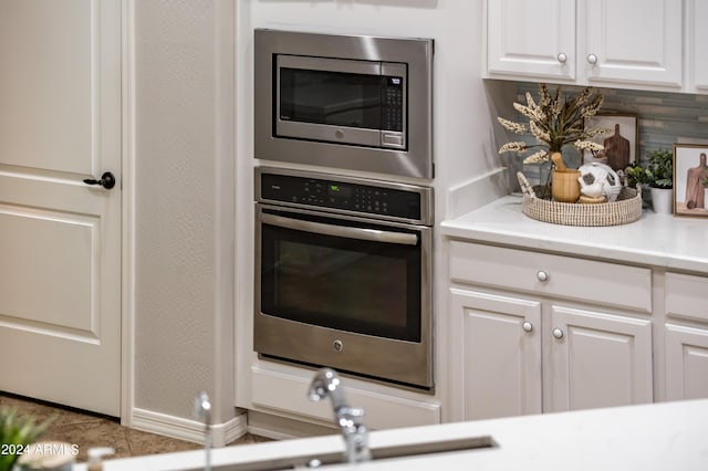 kitchen featuring white cabinetry, sink, tasteful backsplash, and appliances with stainless steel finishes