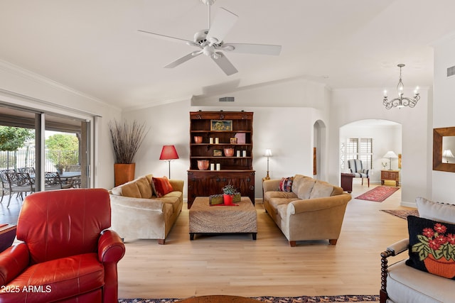 living room featuring vaulted ceiling, ornamental molding, ceiling fan with notable chandelier, and light hardwood / wood-style floors