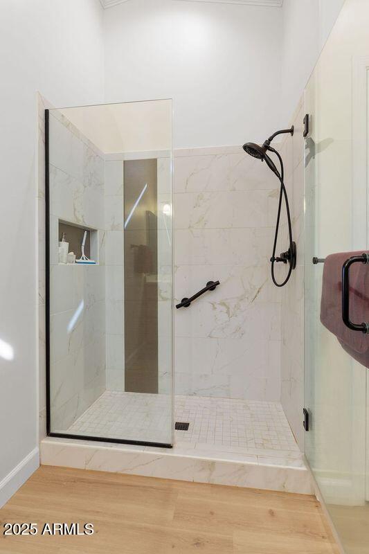 bathroom featuring wood-type flooring and an enclosed shower