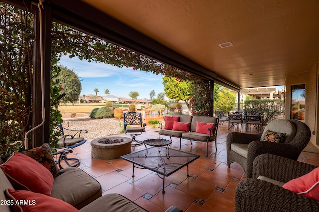 view of patio / terrace featuring an outdoor living space with a fire pit