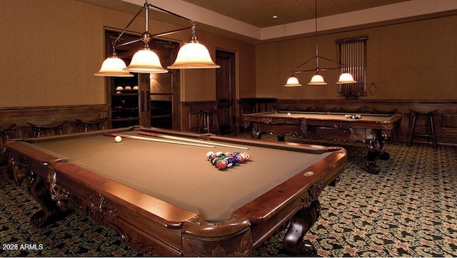 playroom featuring pool table, a tray ceiling, carpet flooring, and wood walls