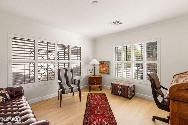 office space with ornamental molding and light hardwood / wood-style flooring