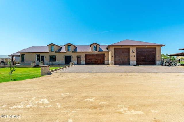 view of front of house with dirt driveway, stone siding, and stucco siding