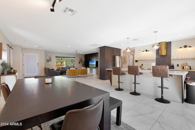 dining area with sink and ceiling fan