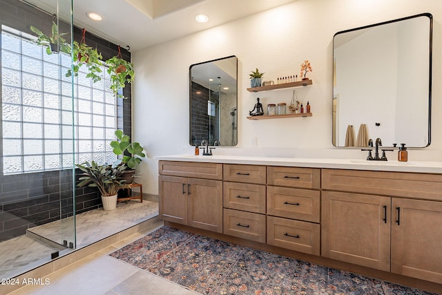 bathroom featuring vanity, a shower with shower door, and tile patterned flooring