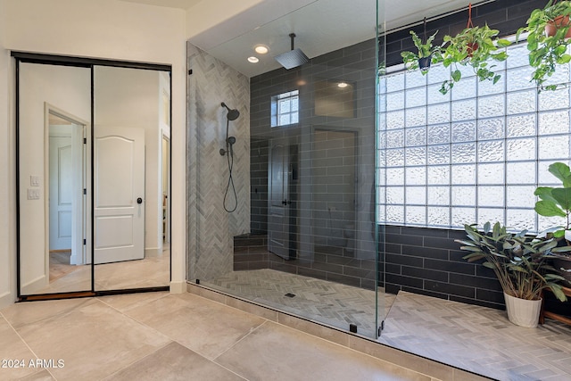 bathroom with tile patterned floors and an enclosed shower