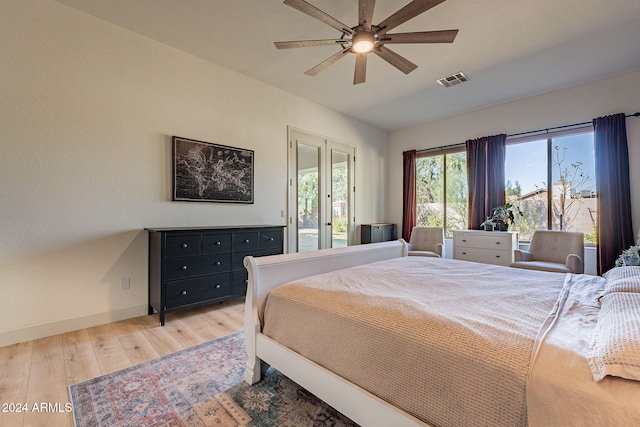 bedroom featuring ceiling fan, hardwood / wood-style flooring, and access to exterior