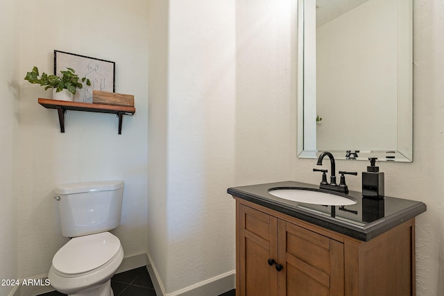 bathroom featuring vanity, toilet, and tile patterned floors