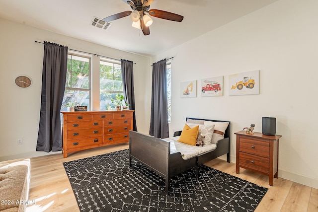 bedroom with wood-type flooring and ceiling fan