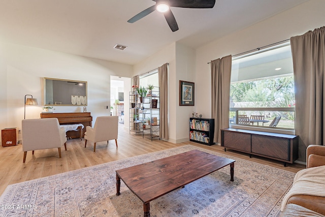 living room with ceiling fan and light hardwood / wood-style flooring